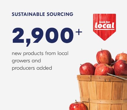 Wooden basket of red apples overflowing.