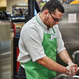 In this image, a man is shown washing his hands.