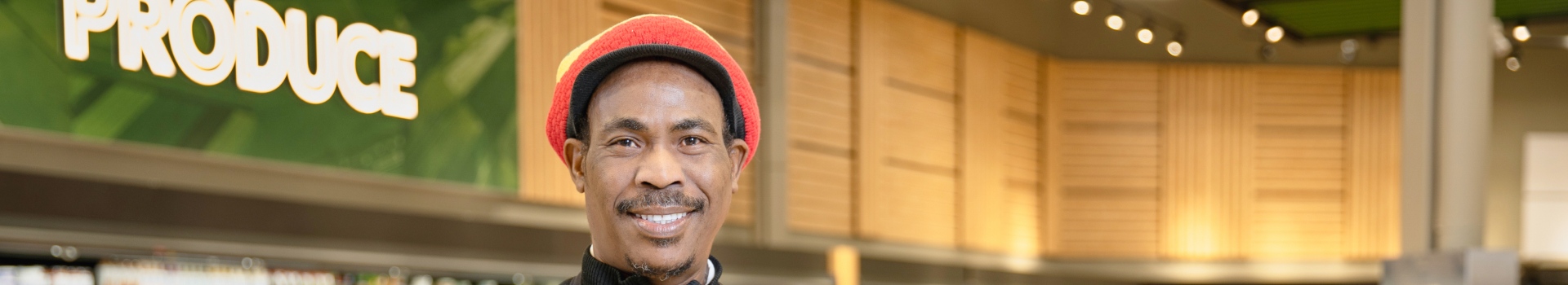 In this image, a man takes a picture with smile.